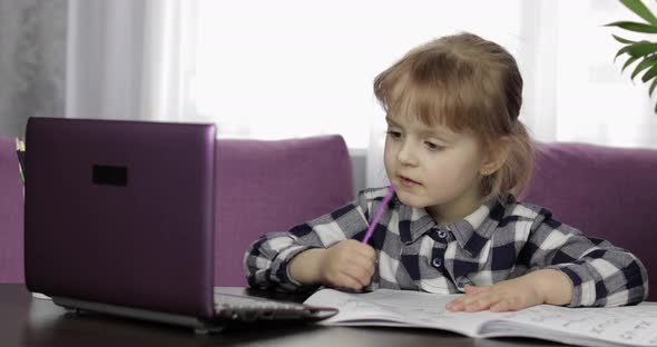 Girl Studying Online Homework Using Digital Laptop Computer. Distance Education