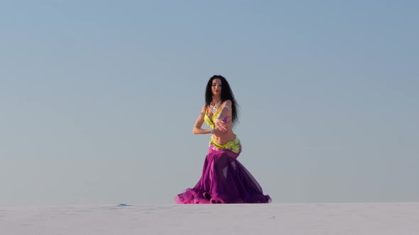 Graceful Dancer Against the Sky Dancing Belly Dance in a Brilliant Outfit