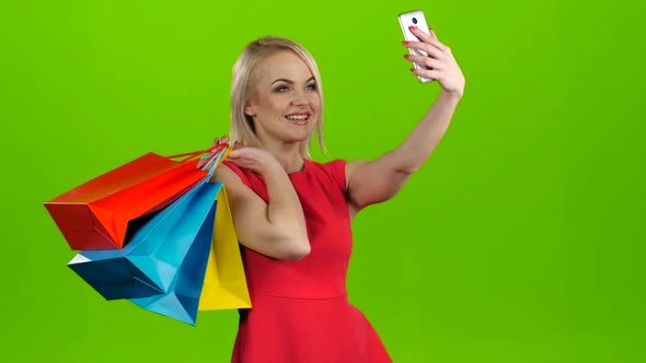 Happy Shopping Woman Makes Selfie on Mobile, Green Screen Studio