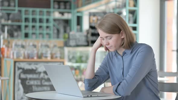 Sleepy Young Woman Taking Nap While Using Laptop