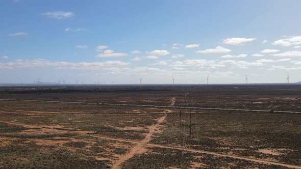 Drone aerial of huge renewable energy wind farm in country Australia with Mountains in the backgroun