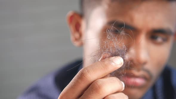 Man Hold His List Hair Close Up