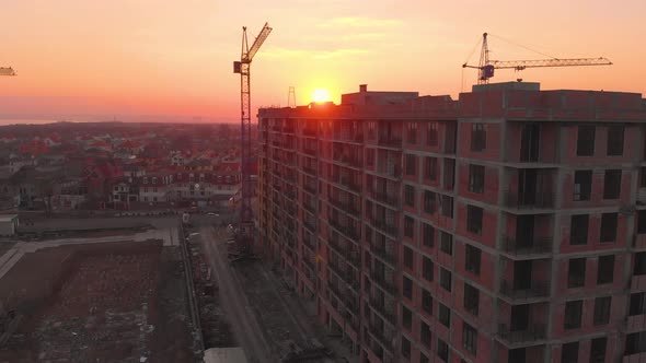 Construction Site in the Middle of the City and Private Houses at Sunset