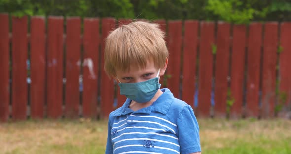 Cute, young boy wearing a face covering to prevent the spread of coronavirus disease.