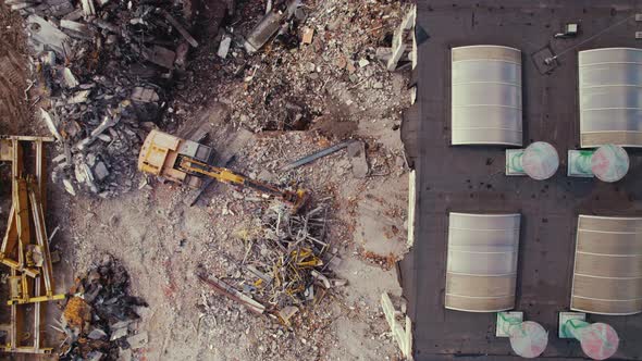 Drone Bird's Eye Perspective of a Yellow Construction Machine Operated By a Person During New
