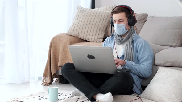 Young Businessman Working at Home with Face Mask