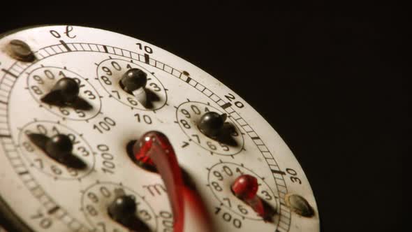 Vintage Gas Meter from 70s of 20th Century. The Red Hand Rotates Around the Dial. Closeup