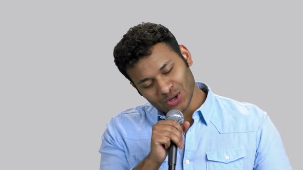 Portrait of Handsone Darkskinned Man Performing Song with Microphone