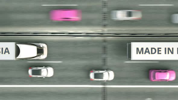 Trucks with MADE IN RUSSIA Text Driving Along the Road alt