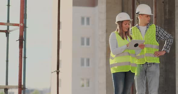 Portrait of Construction Engineers Working on Building Site