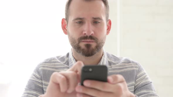 Man Using Smartphone at Work