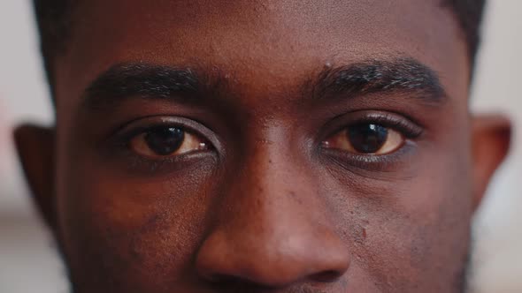 Closeup Macro Portrait of Beauty Young African American Man's Eyes Smiling Model Looking at Camera