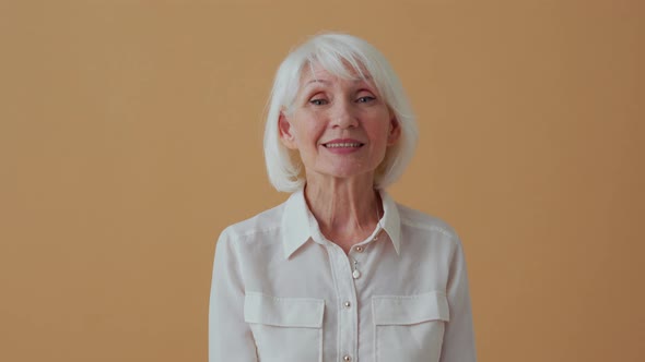 Happy mature woman positively shaking her head