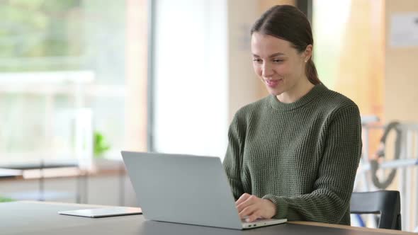 Talking Young Woman Doing Video Chat on Laptop