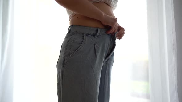 A Young Girl Shakes Her Belly Fat in Despair Buttons Up Her Pants