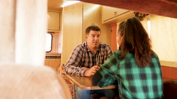 Passenger View of Couple Talking Inside of Their Retro Camper Van