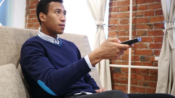 Excited African Man Watching Match on TV Celebrating Success