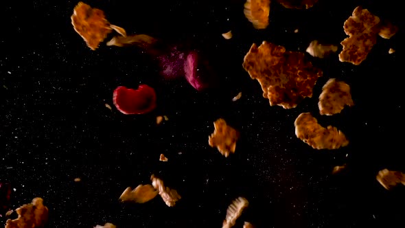 Corn Flakes with berries falling to the ground. Studio shot filmed from below with two hits.