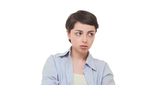 Dissatisfied Caucasian Girl with Short Haircut Standing Over White Background Heavily Sighing and