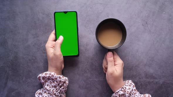 High Angle View of Women Hand Using Smart Phone and Drinking Coffee