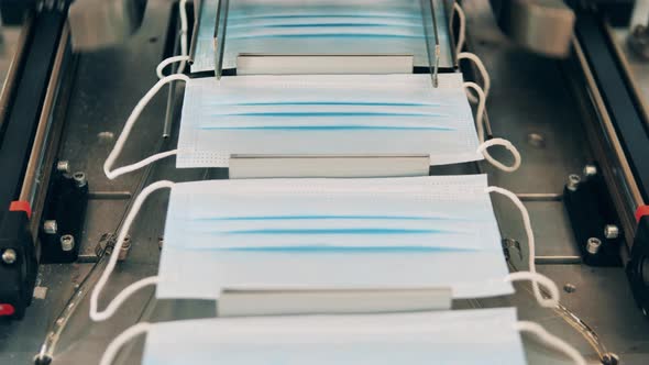 Coronavirus Protection Mask Production Line. Face Masks Moving Along a Conveyor at a Face Mask