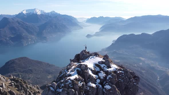 Flight around hikers on top of a mountain, European Alps, Como, Italy