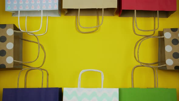 Yellow Background with Different Paper Bags Around the Perimeter, Stop Motion 