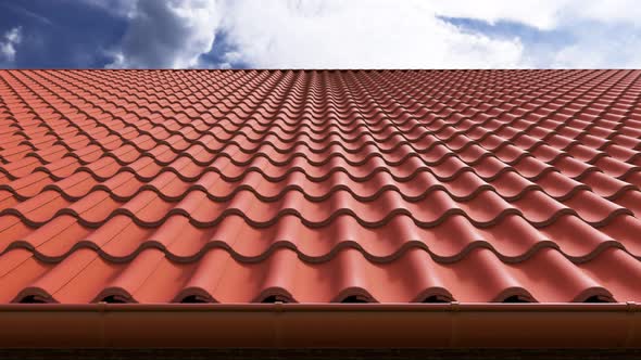 Animation of a house with the red clay tiled roof on a clear sky at background.