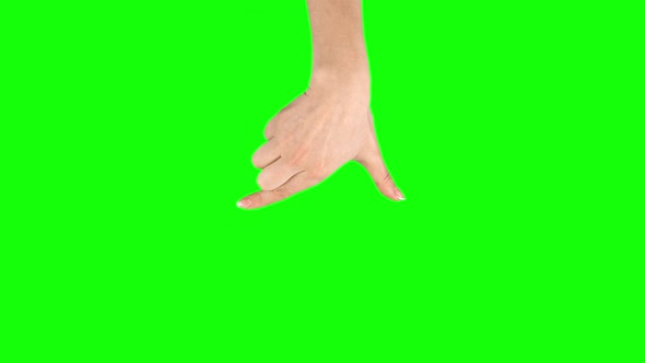 Female Hand Is Performing Press and Drag at Tablet Screen Gesture on Green Screen. Close Up