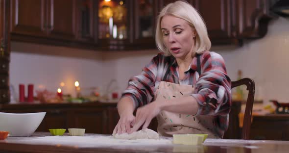 Blond Caucasian Woman Kneading Dough Sneezing Flour Flying Around