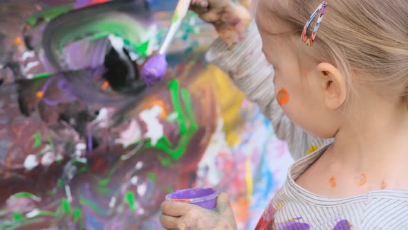 Happy Little Girl Painting with Watercolors