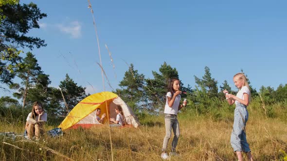 Happy children resting in nature in a tent. Nature. Forest. Fresh air.