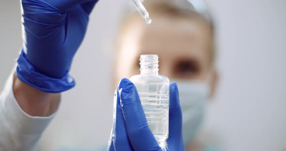 Female Scientist Using Pipette Analyzes a Liquid alt