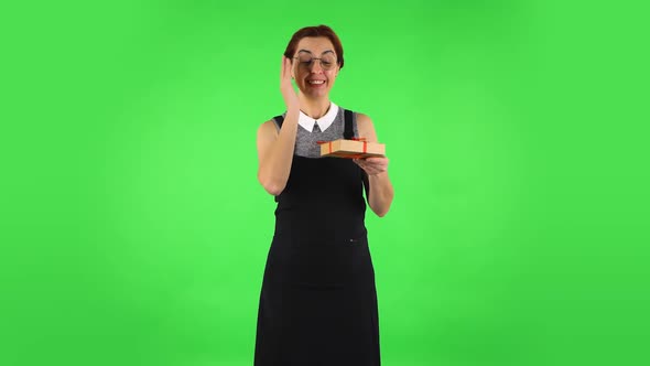Funny Girl in Round Glasses Is Opening the Gift, Very Surprised and Getting Upset. Green Screen