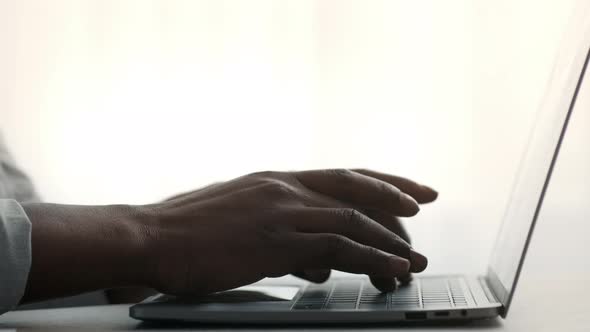 Closeup Of Black Male Hands Typing On Laptop Keyboard Indoors