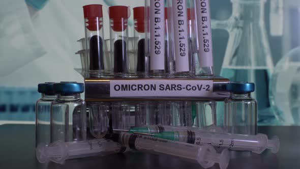 Taking test tubes with Omicron label for sample collection and testing at laboratory.