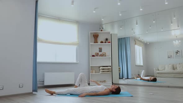 Young Woman Practicing Yoga in Studio