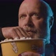 Focused senior man eating popcorn and watching a suspense movie at the cinema - VideoHive Item for Sale