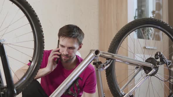 Man Sits Near Broken Bicycle Calls Service