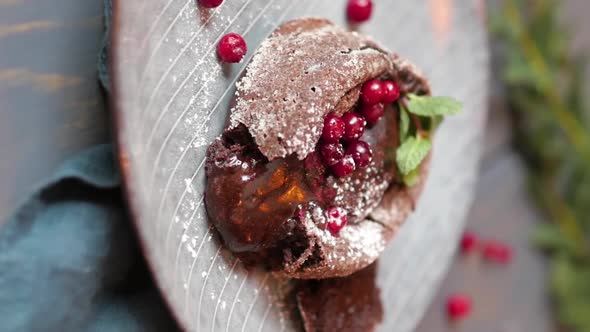 Dessert Chocolate Fondant on a Wooden Background with Berry Decoration