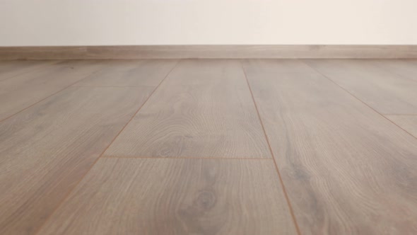 New laminate flooring. Laminated parquet with brown wooden texture