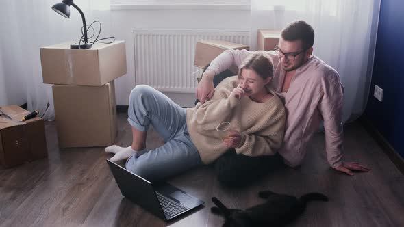 Happy Couple Relaxes After Moving in a New Home