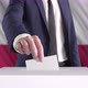 Voting. Man Putting a Ballot into a Voting Box with Poland Flag on Background. - VideoHive Item for Sale