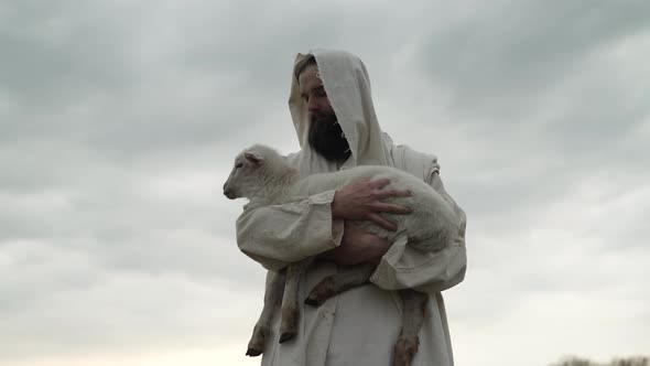 Jesus Christ The Christian Good Shepherd Holds A Lamb