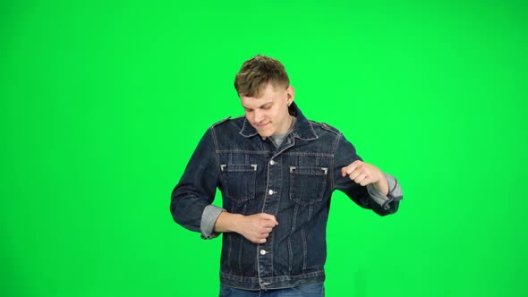 Friendly Man Goes and Dances, Smiles and Rejoices on a Green Screen, Chroma Key. Slow Motion