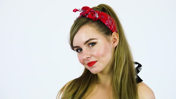 A Beautiful 50s Pin up Girl Smiles at the Camera Face Closeup - White Screen Background