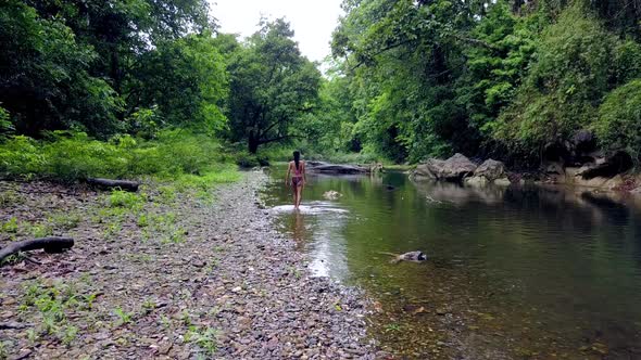 Young Woman in Bikini Walking in the River Thailand