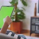 woman holding in hands a digital tablet with green screen for internet online. - VideoHive Item for Sale