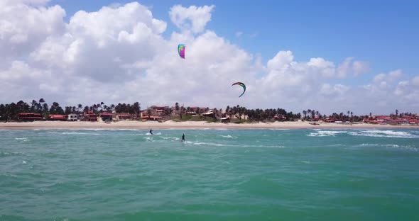 Aerial drone view of a woman kiteboarding on a kite board