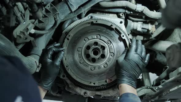 Change and repair clutch, drive axle. working underneath a lifted car